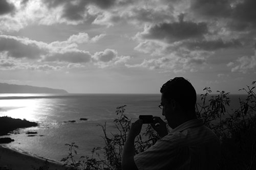 Kevin Worthington capturing a photo high above Waimea Bay Beach